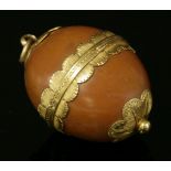A Victorian oval nut box or fob, with fluted hinged mounts and scalloped caps to the top and bottom,