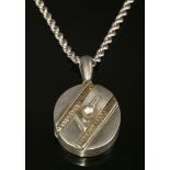 A late Victorian silver hinged locket and chain,of flat section oval form. Jarretière-style diagonal