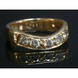 A gold diamond set wave half eternity ring,with five brilliant cut diamonds, grain set to a flat