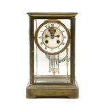 A French brass four glass mantel clock, with mercury pendulums and visible escarpment, striking on a