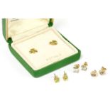 A collection of stud earrings, to include a pair of gold circular cut peridot earrings (tested as