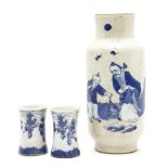 An Oriental blue and white crackleware vase, together with a pair of small blue and white flaring