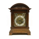 A 19th century oak eight day bracket clock, with silvered chapter ring and brass dial, with cast