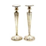 A pair of Birks sterling silver candlesticks, of fluted circular tapering form on a circular