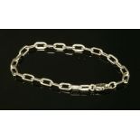 A white gold Cartier 'Spartacus' bracelet, composed of a series of oval trace links with a side