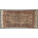 A hand knotted Persian prayer rug, the biscuit central field with repeating geometric shapes, within