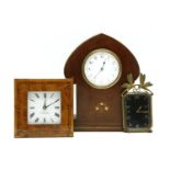 An Art Nouveau mahogany mantel clock, in arabesque shaped case, with inlaid decoration, 25cm tall,