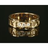 A ladies' 18ct rose gold diamond set Tiffany 'Atlas' band ring, with three brilliant cut diamonds,