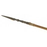 A Fijian fishing spear, the carved head with a pivoting metal barb, the wooden shaft with three