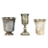 A Russian silver beaker, another beaker with spreading foot, possibly silver, and a sterling