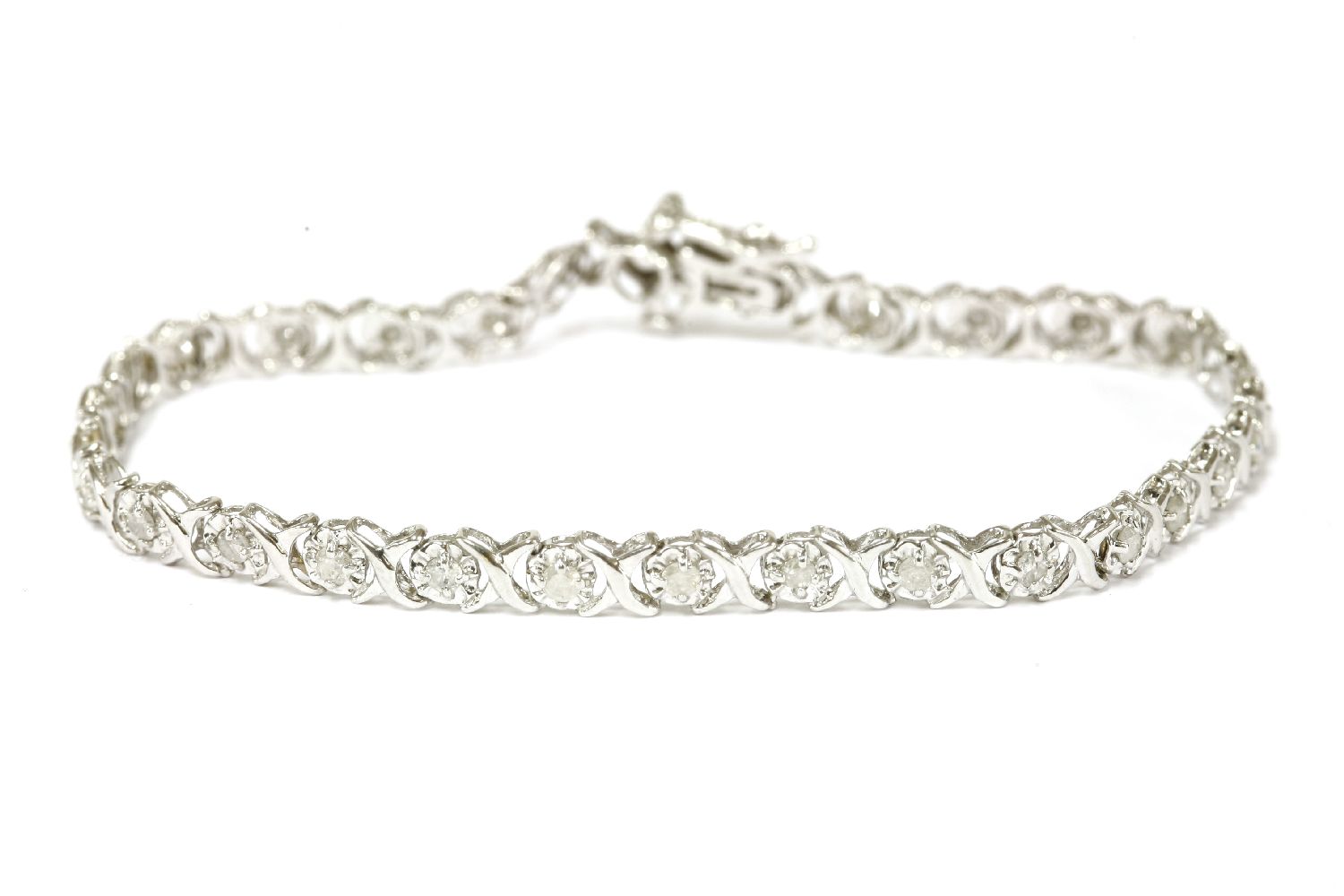 A 9ct white gold illusion set brilliant cut diamond line bracelet