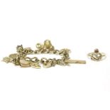 A gold charm bracelet with 9ct gold padlock and eleven assorted charms, to include a New York