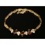 An Edwardian garnet and split pearl bracelet, c.1910, with a centrepiece composed of a series of
