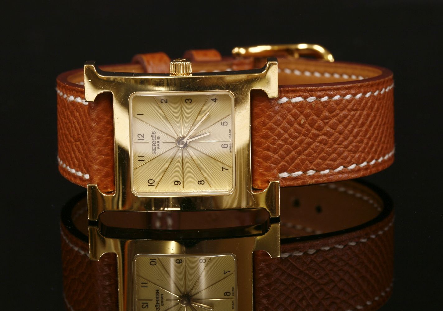 A ladies' gold plated Hermès Heure H quartz strap watch. Model no. HH1.201. Square engine turned