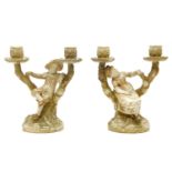 A pair of Royal Worcester twin branch candelabra, the central figural decorated branch flanked to