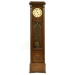 An oak longcase clock, with a silvered dial in a rectangular case with carved detail, 220cm high