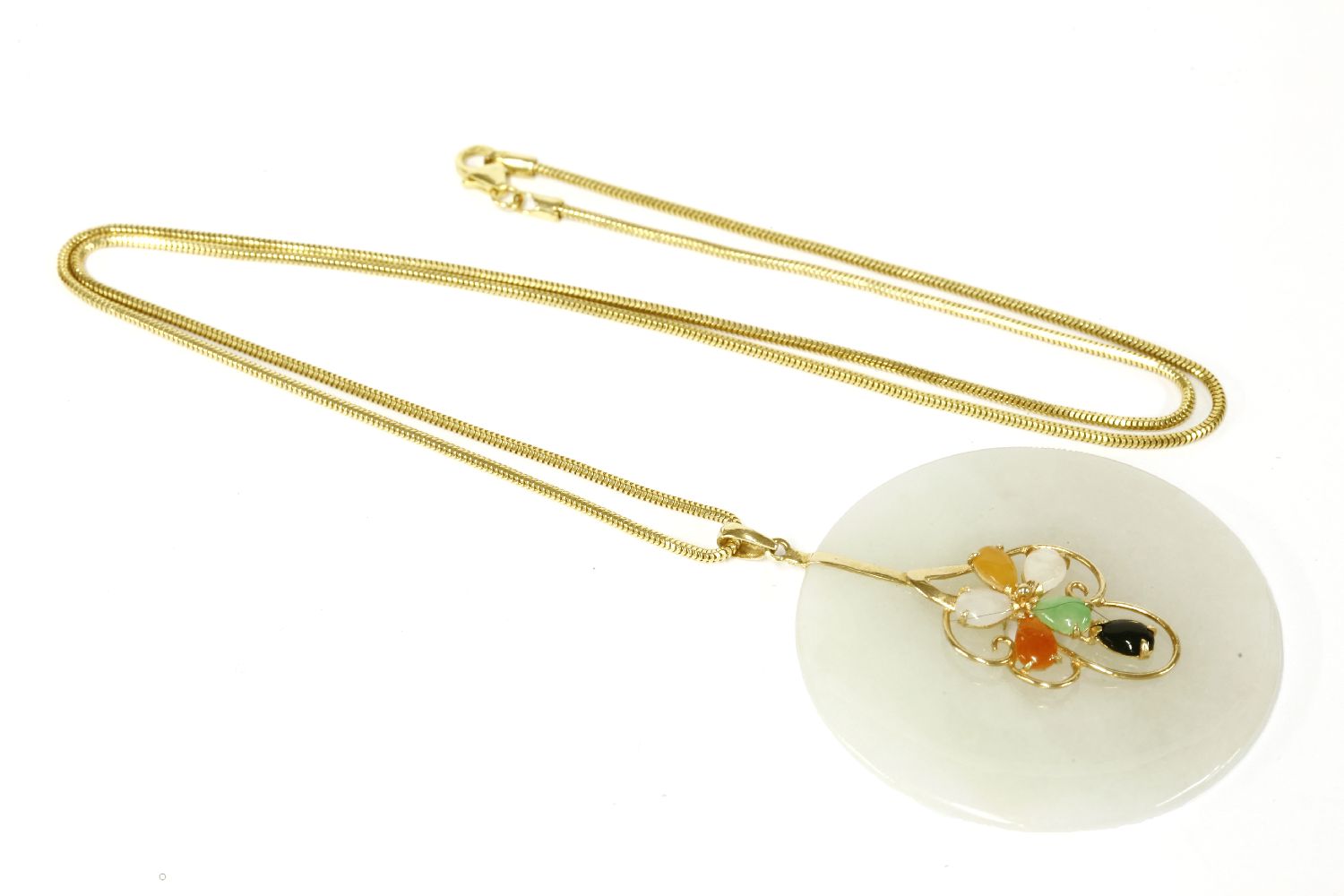 A 14ct gold jade bi pendant, with applied gold and hardstones, in a floral motif on an Italy