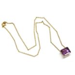 A gold emerald cut amethyst pendant, claw set to a gilt metal trace chain, (pendant tested as 18ct