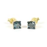 A pair of gold single stone treated blue diamond studs, marked 9k, 1.11g