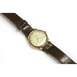 A gentlemen's 9ct gold Trebex mechanical strap watch, silvered dial with Arabic numerals and