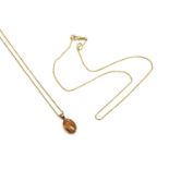 A 9ct rose gold oval agate pendant, rub set to a 'V' shaped bale, suspended on a fine belcher link