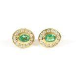 A pair of 9ct gold channel set oval emerald and diamond cluster studs, 1.12g