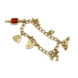 A 9ct gold curb link bracelet with padlock, and six assorted charms including a 9ct gold Dacshund