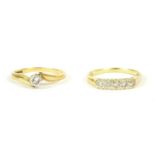 An 18ct gold single stone diamond crossover ring, a brilliant cut diamond claw set to a white