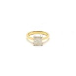 An 18ct gold single stone modified princess cut diamond ring, claw set to a white underbezel, to