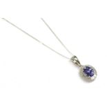 A 9ct white gold tanzanite and diamond cluster pendant, on chase chain, 1.81g