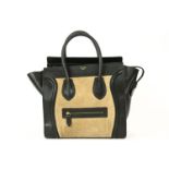 A Celine black 'luggage' leather handbag, designed in a black leather and taupe suede exterior,