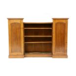 A Victorian mahogany bookcase, enclosed by a pair of panelled doors flanking open shelves, 186cm