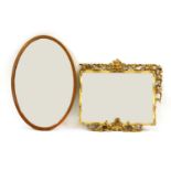 A George III style carved and pierced giltwood wall mirror, (a/f) 70cm x 85cm, together with an oval