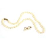 A single row of uniform cultured pearls, strung knotted to a 9ct gold single cultured pearl safety
