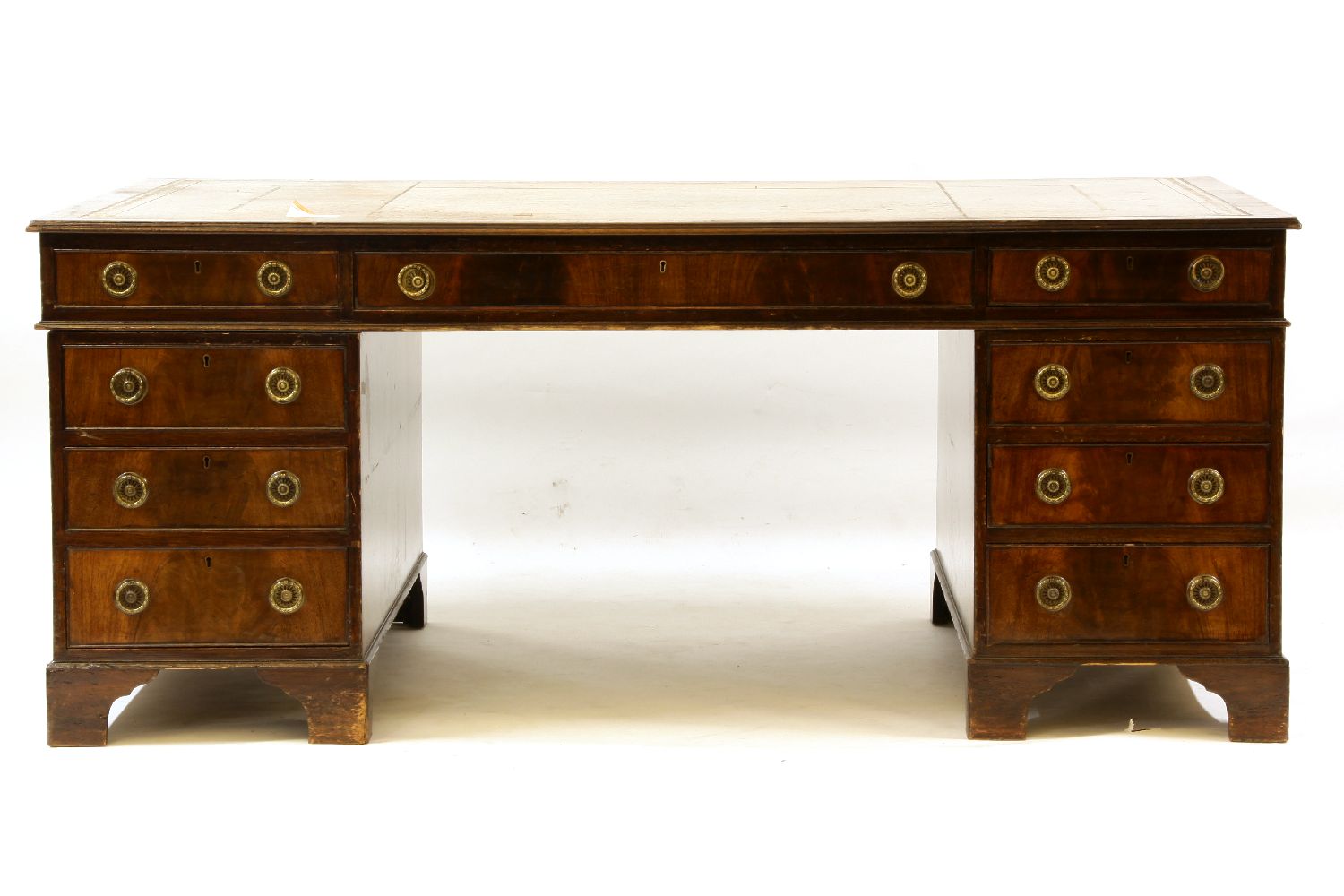A large reproduction mahogany partner's desk, the leather inset top over three frieze drawers and
