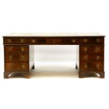 A large reproduction mahogany partner's desk, the leather inset top over three frieze drawers and