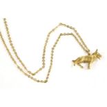 A 9ct gold German Shepherd pendant, with ruby set eyes on a trace chain, 12.78g