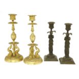 A pair of bronze candlesticks, in the form of weeping women in classical dress, 20cm high,