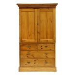 A Victorian stripped pine linen press, with base drawers, 122cm wide, 60cm deep, 211cm high