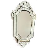 A large Venetian design wall mirror, the bevelled central plate with scrolling leaf cresting and