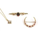 A gold split pearl and ruby open crescent brooch, a gold garnet set bar brooch, and a 9ct gold cubic