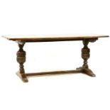 A mid 20th century Jacobean style oak refectory table, with planked top on baluster supports,