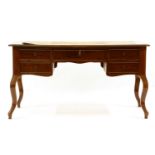 A French mahogany library table, the top with a leather inset over five frieze drawers and