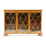 An Edwardian mahogany dwarf bookcase, fitted three lattice bar and glazed doors on bracket feet,