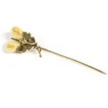 A Continental stick pin, in the form of acorns made from stag teeth, marked 585, possibly German,