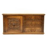 A Victorian oak side cabinet, fitted with a single cupboard and three drawers, all with ornately