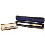 A silver and ivory handled breadknife, cased and a set of six silver and enamel buttons