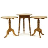 A pair of pine occasional tables each on turned support and tripod base, each 56cm diameter, 66cm