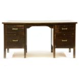 A mid 20th century stamped oak desk, the leather top raised on twin two drawer pedestals, 152cm