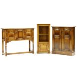 A reproduction panelled oak cabinet, with two doors, 74cm wide, 25cm deep, 89cm high, a narrow